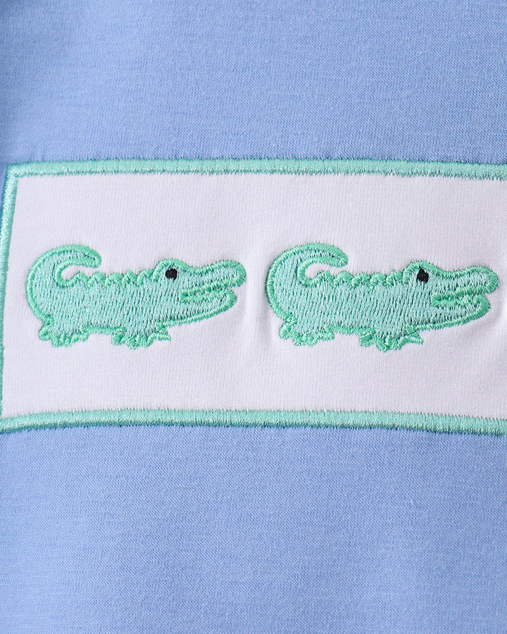 Green crocodile embroidery on white patch with mint border