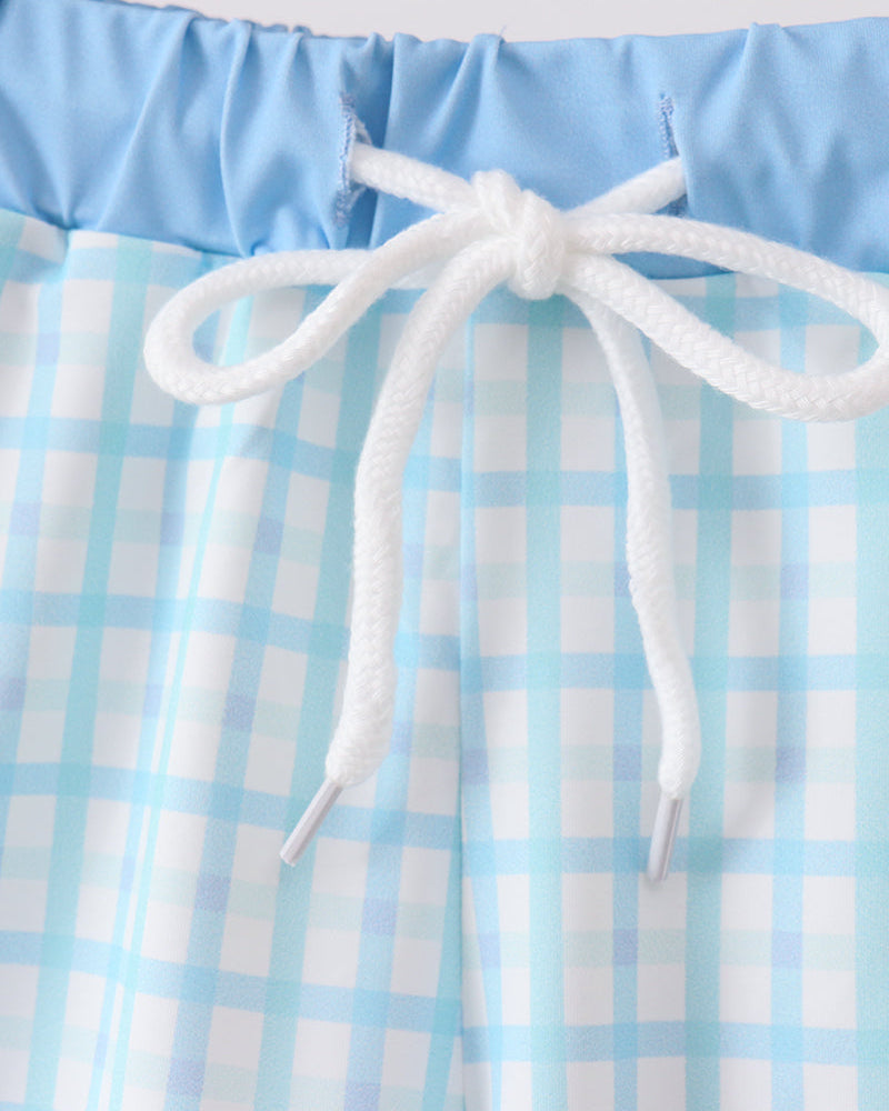 Light blue plaid swim trunks with white drawstring and elastic waistband.