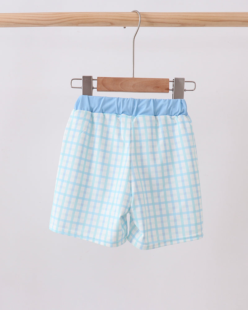Light blue plaid swim shorts with white elastic waistband and drawstring ties.