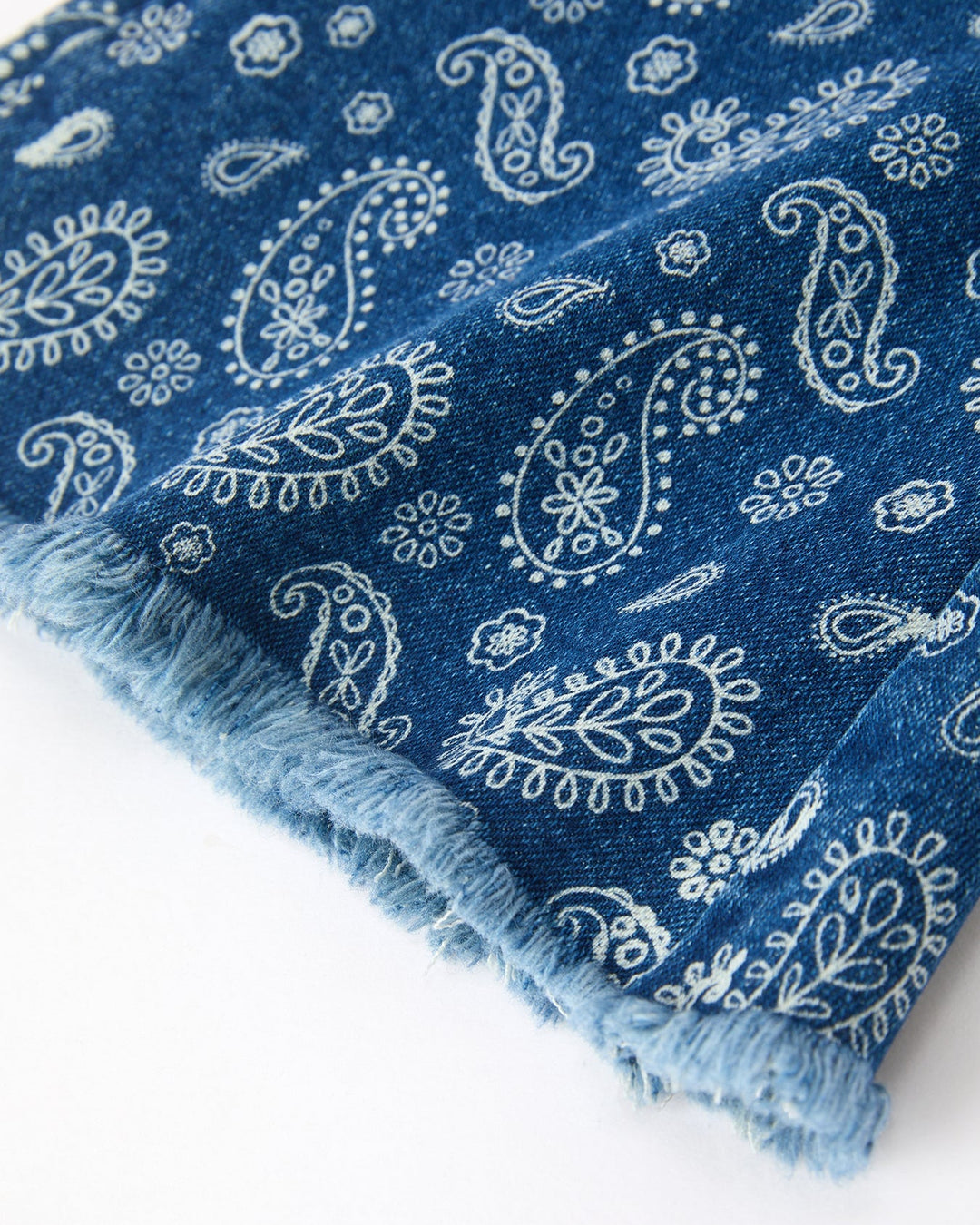 Girls denim bell-bottom cuffs with frayed edge and white paisley print on blue denim