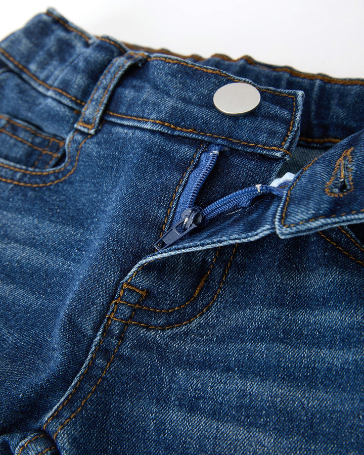 Girls denim jeans close-up of button, waistband, and zip fly
