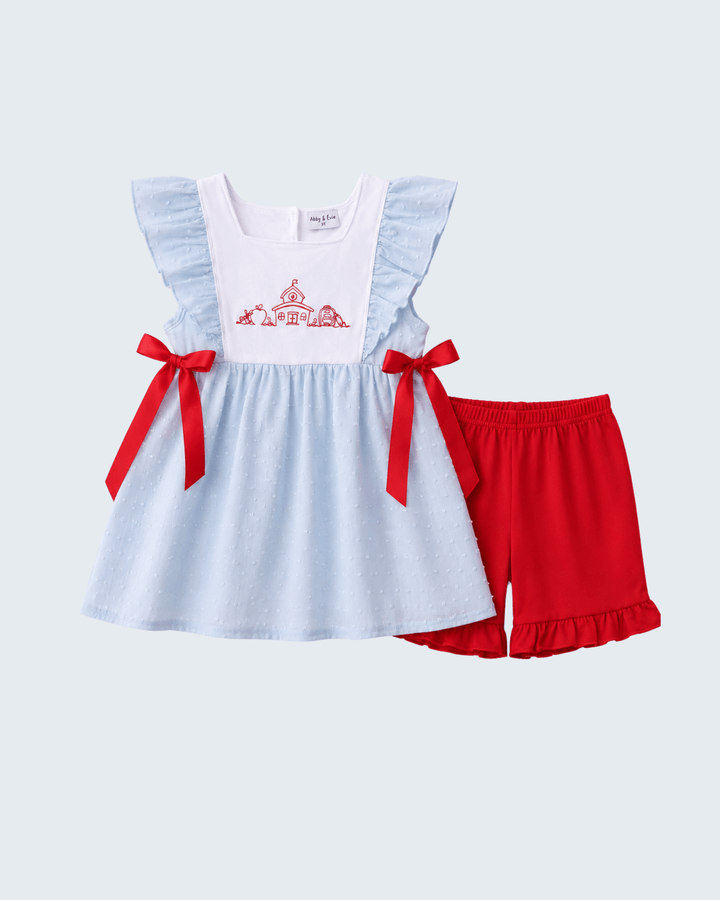 Light blue Swiss dot ruffle dress with red bow straps and matching red shorts