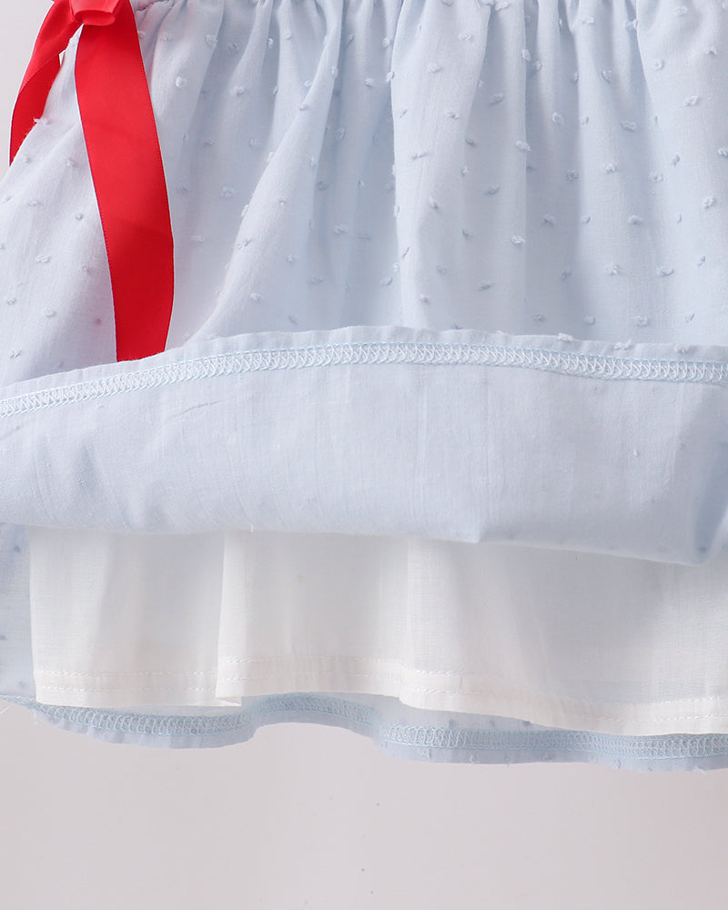 Light blue dress skirt with Swiss dot texture, white ruffle hem, and red bow