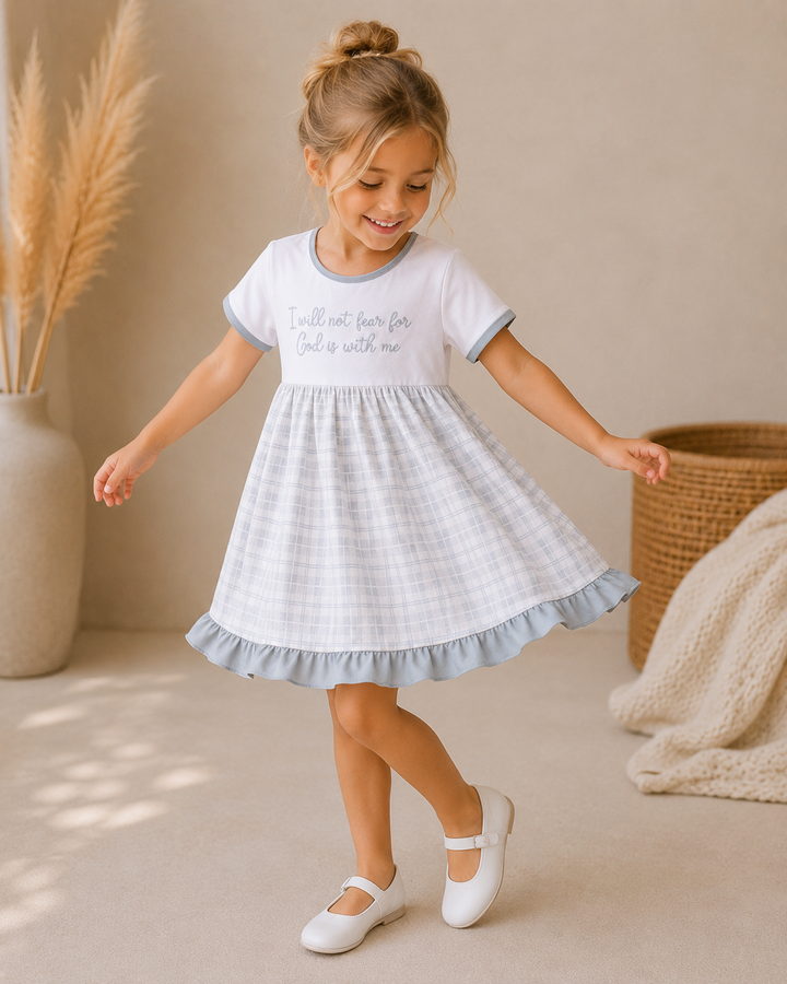 Girls’ faith quote dress in white with light gray plaid and fluttery ruffle hem