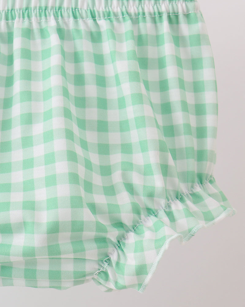 Green and white checkered baby bloomers on a light gray background