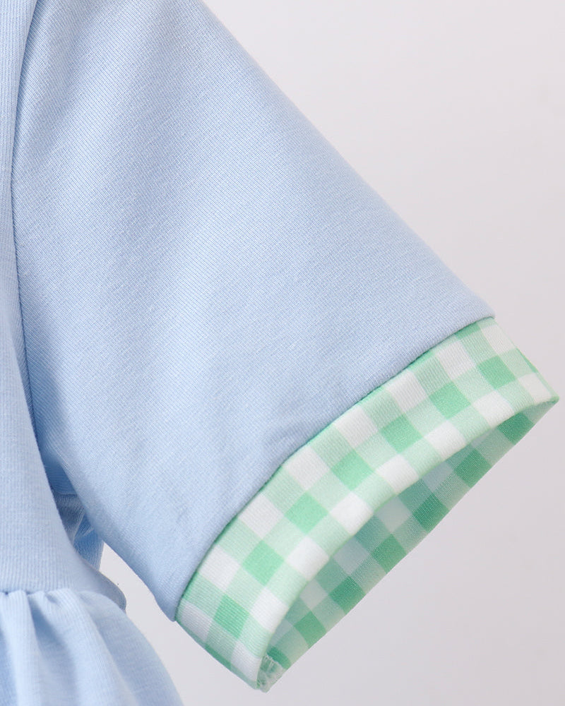 Light blue fabric with a green checkered trim on a light gray background
