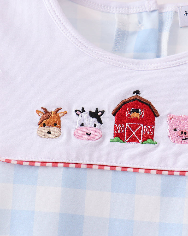 Embroidered farm animals on light blue gingham shirt front, with red trim
