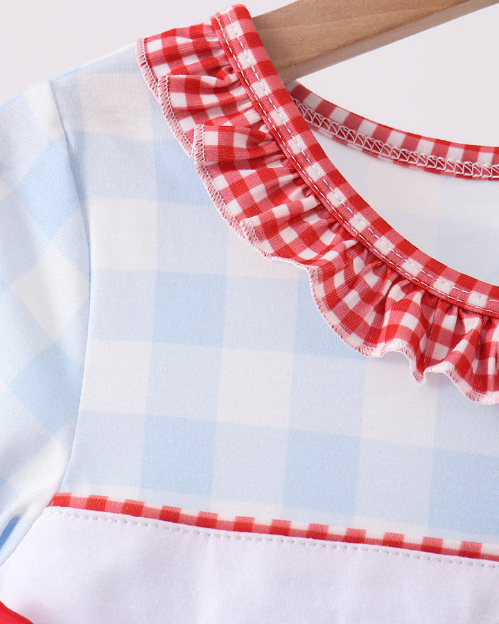 Shoulder and neckline close-up: light blue gingham dress with red ruffle trim and embroidery