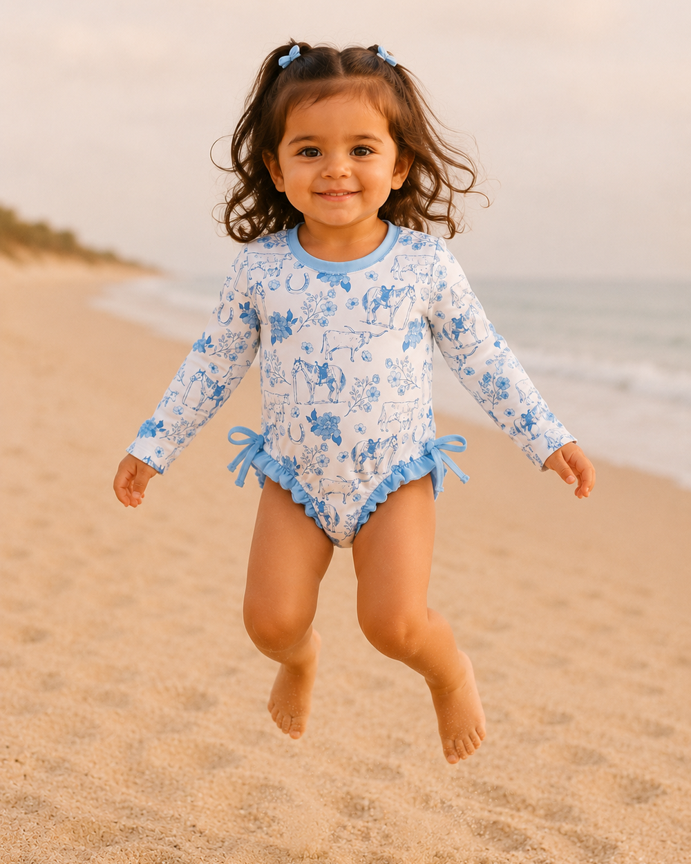 Child in a floral swimsuit running on a beach