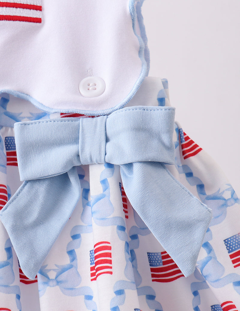 Baby outfit with bow and American flag pattern on a white background