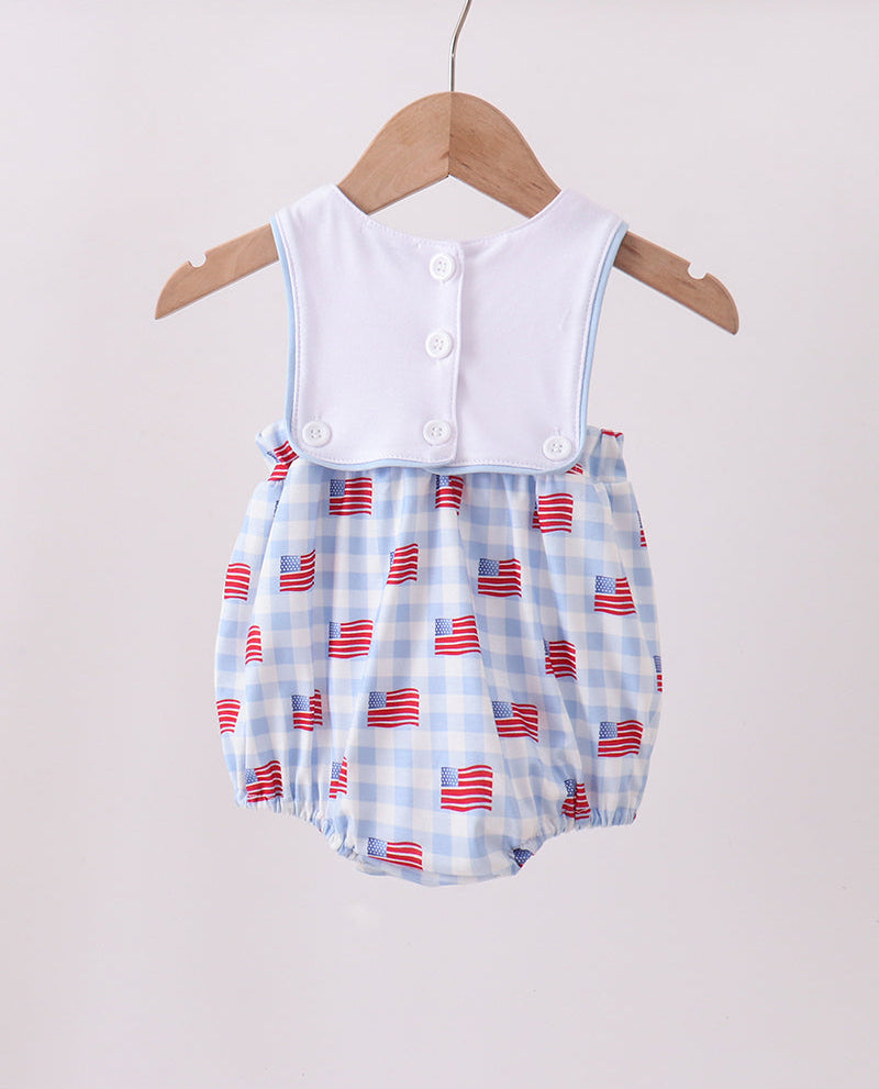 Baby romper with American flag pattern on a wooden hanger against a light background