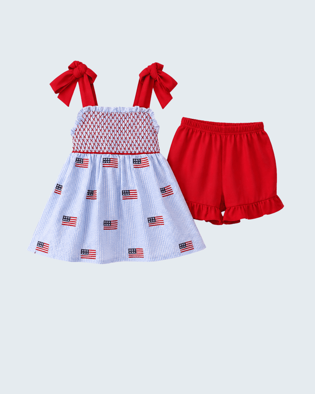 Children's outfit with red and white dress and shorts on a light gray background