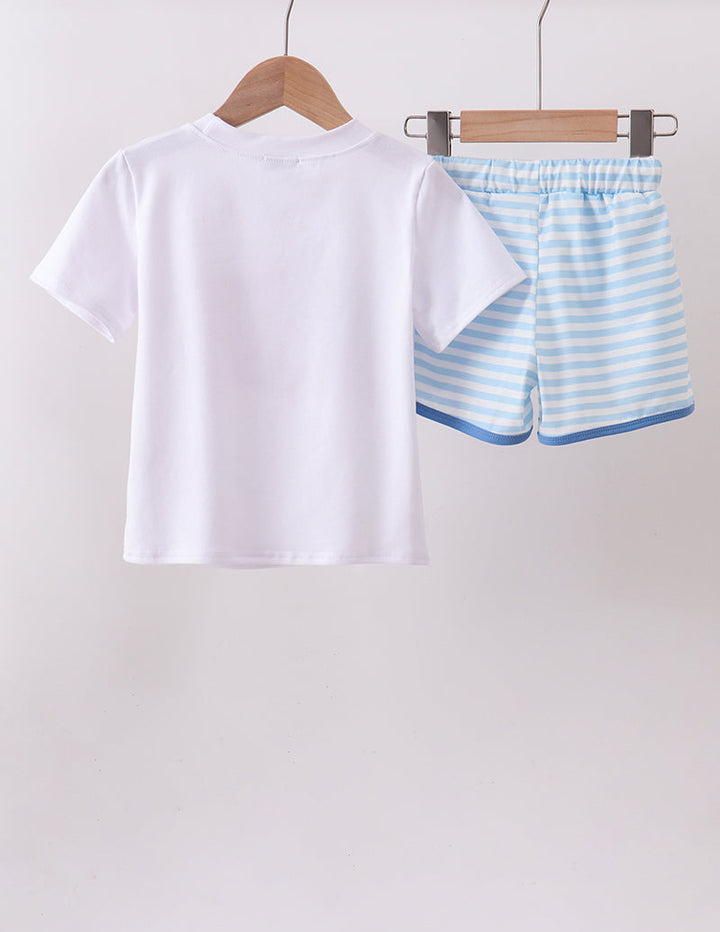 White t-shirt and blue striped shorts on hangers against a white background