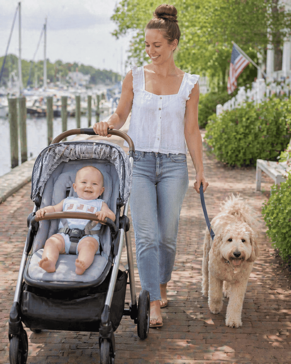 mom walking dog and baby in stroller
