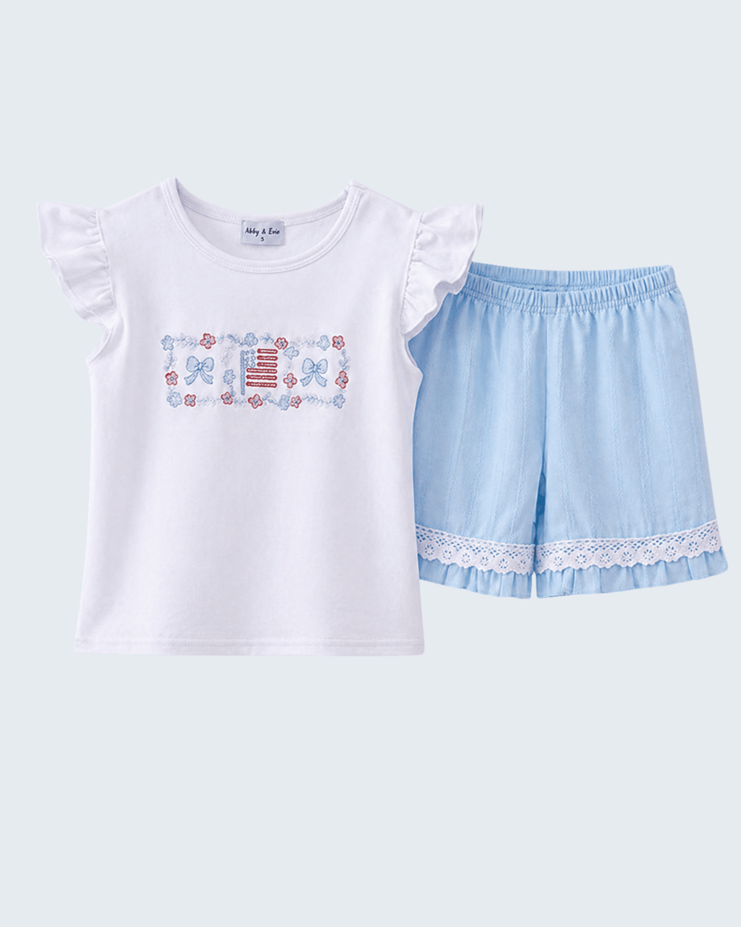 White t-shirt with butterfly design and light blue shorts on a white background