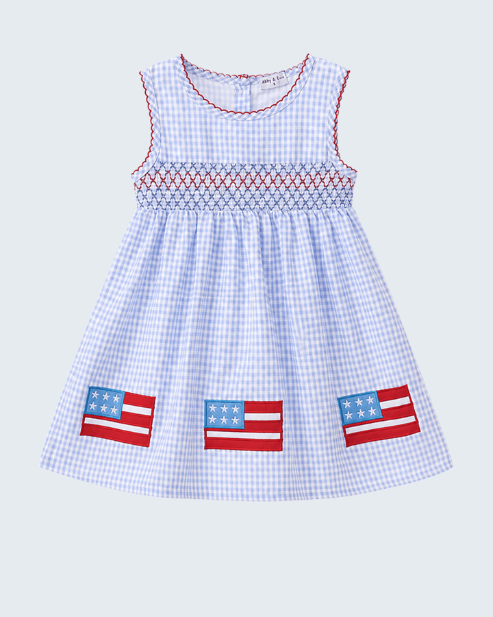 Checkered dress with American flag patches on a light gray background