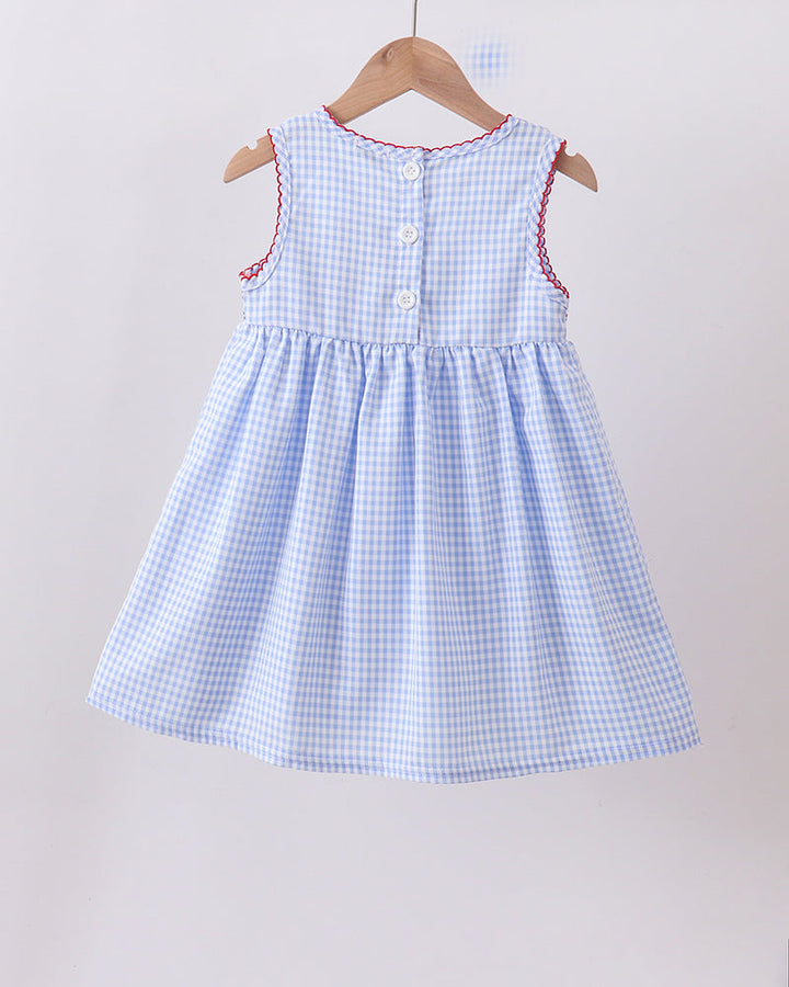 Blue checkered dress on a hanger against a plain background
