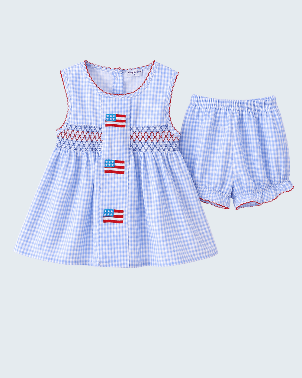 Children's blue checkered outfit with American flag design on a light gray background