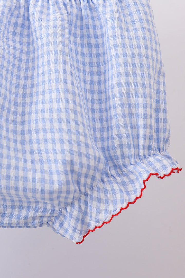 Blue and white checkered shorts with red trim on a light gray background