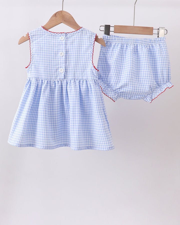 Baby dress and diaper set with blue checkered pattern on hangers against a white background
