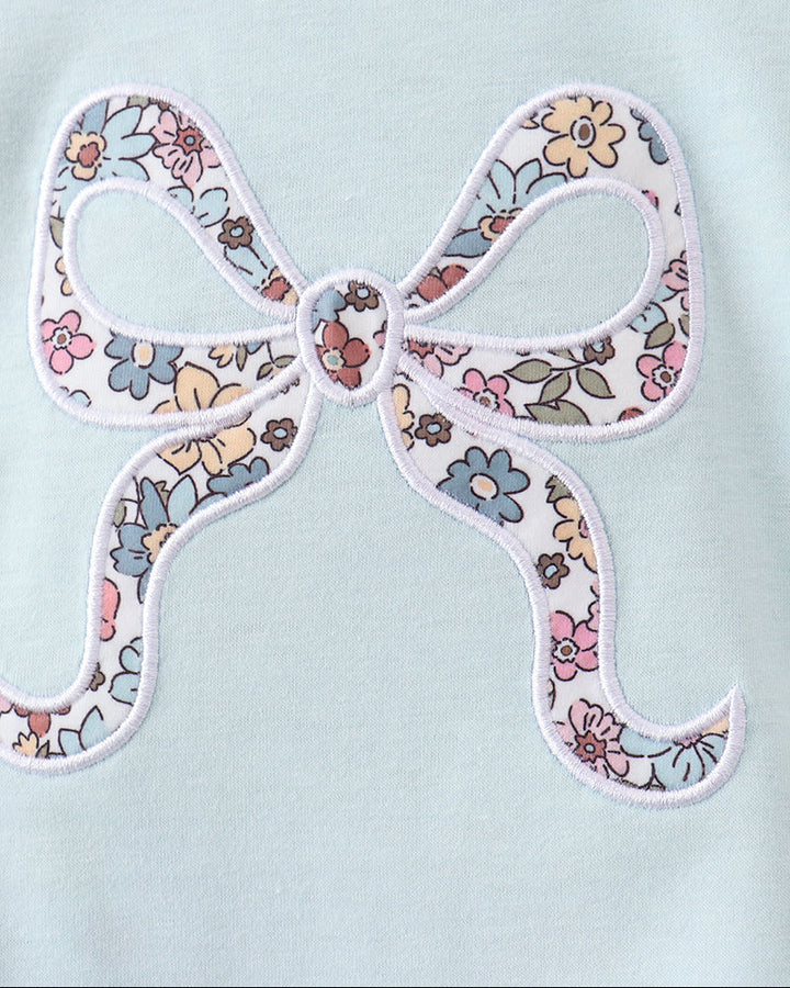 Light aqua romper with multicolor floral bow applique at the chest