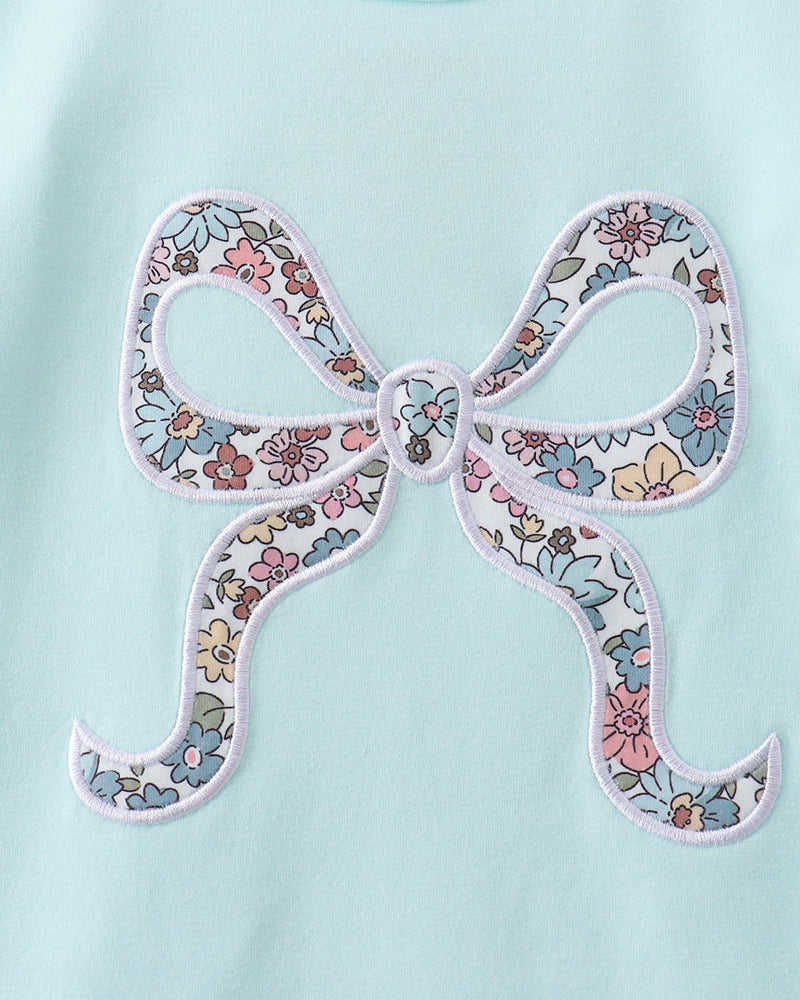 Light aqua long-sleeve top with large floral bow applique