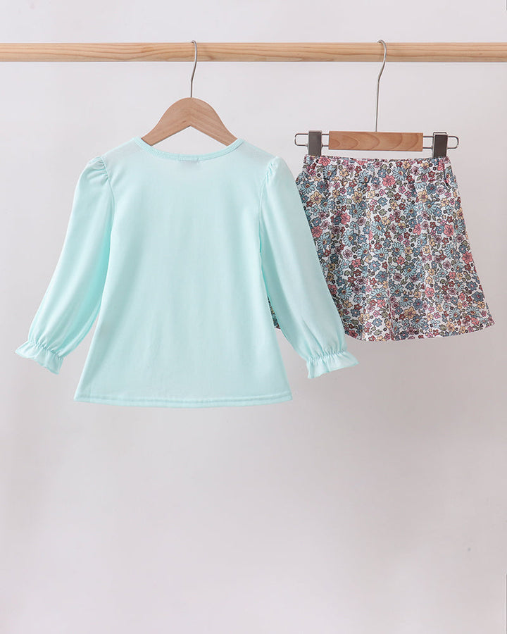 Back view mint blue long-sleeve top with floral skort bottoms