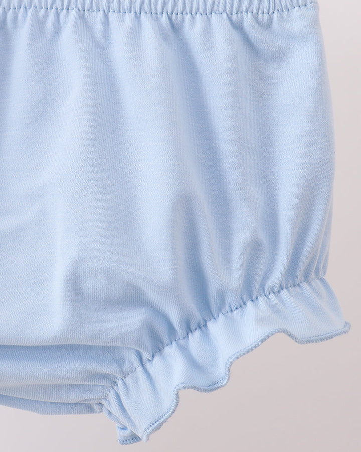 Light blue baby bloomers on a beige background