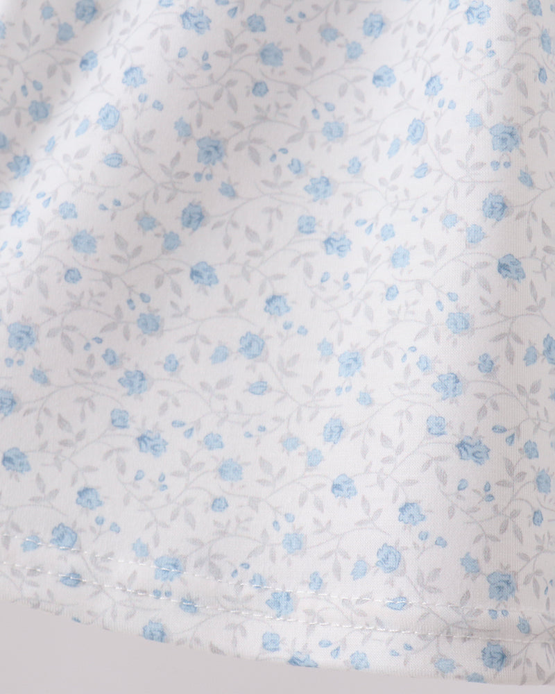 Floral patterned fabric with small blue flowers on a white background