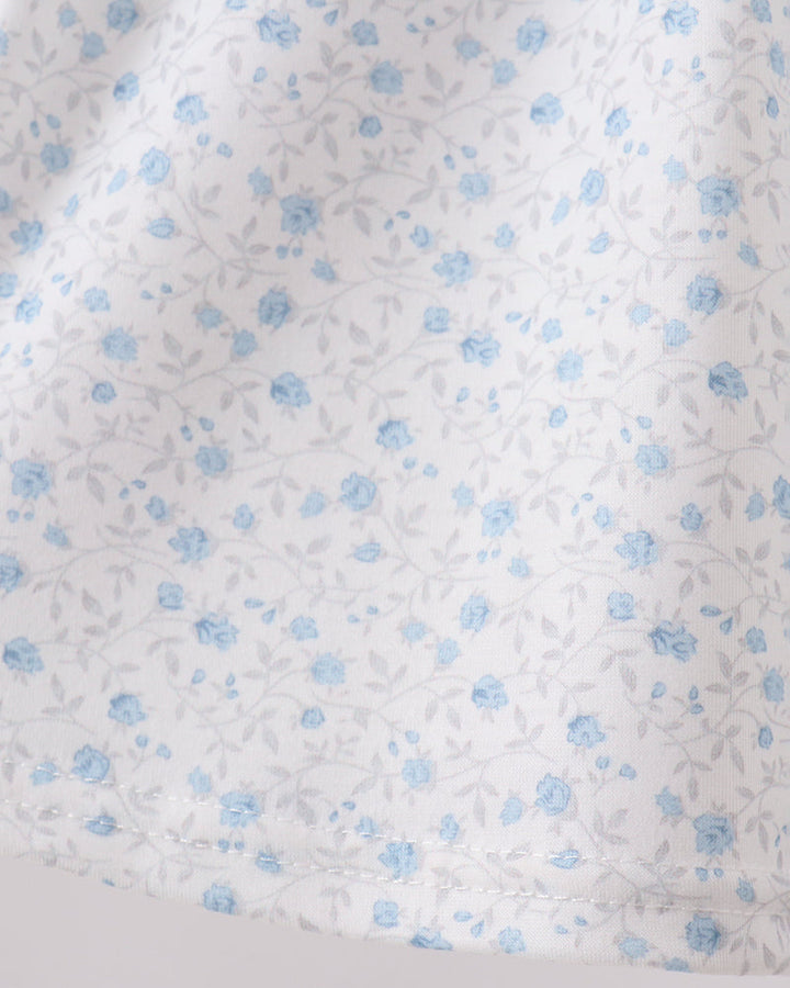Floral patterned fabric with small blue flowers on a white background