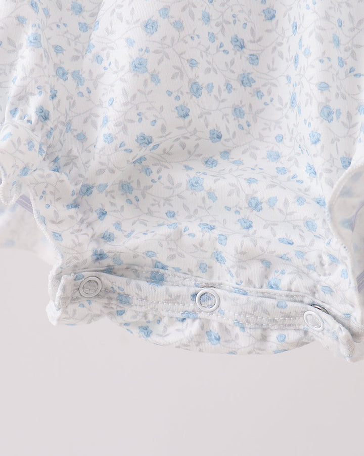 Baby onesie with blue floral pattern on a white background