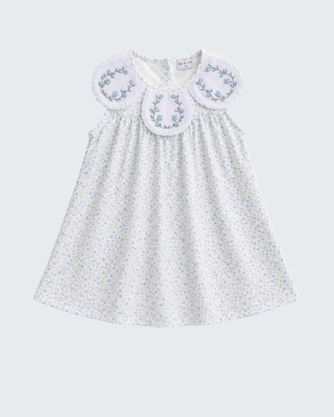 White dress with floral embroidery on a light gray background