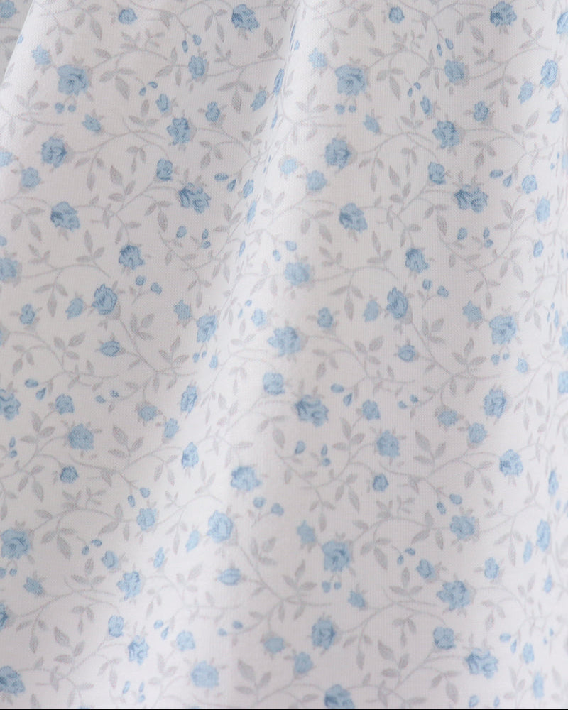 White fabric with small blue floral pattern