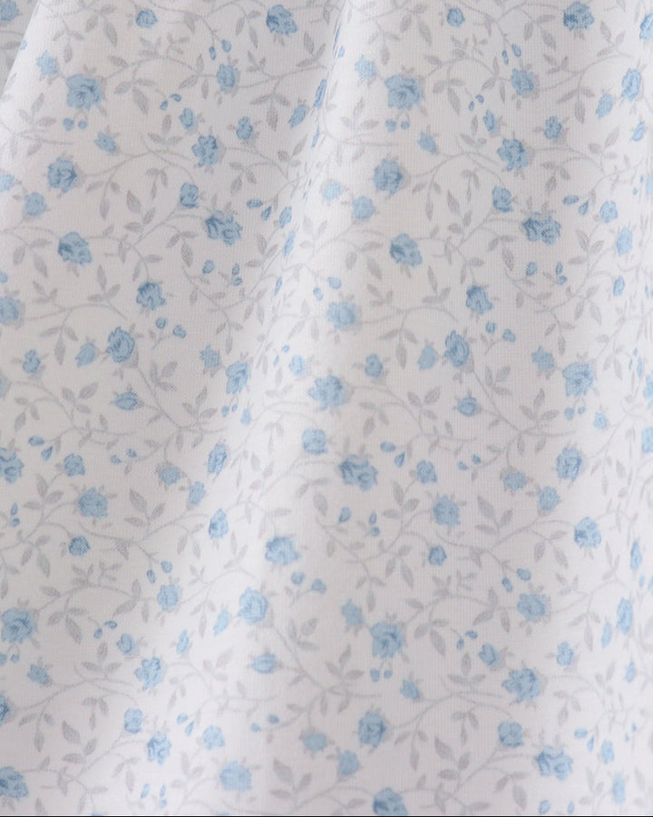 White fabric with small blue floral pattern