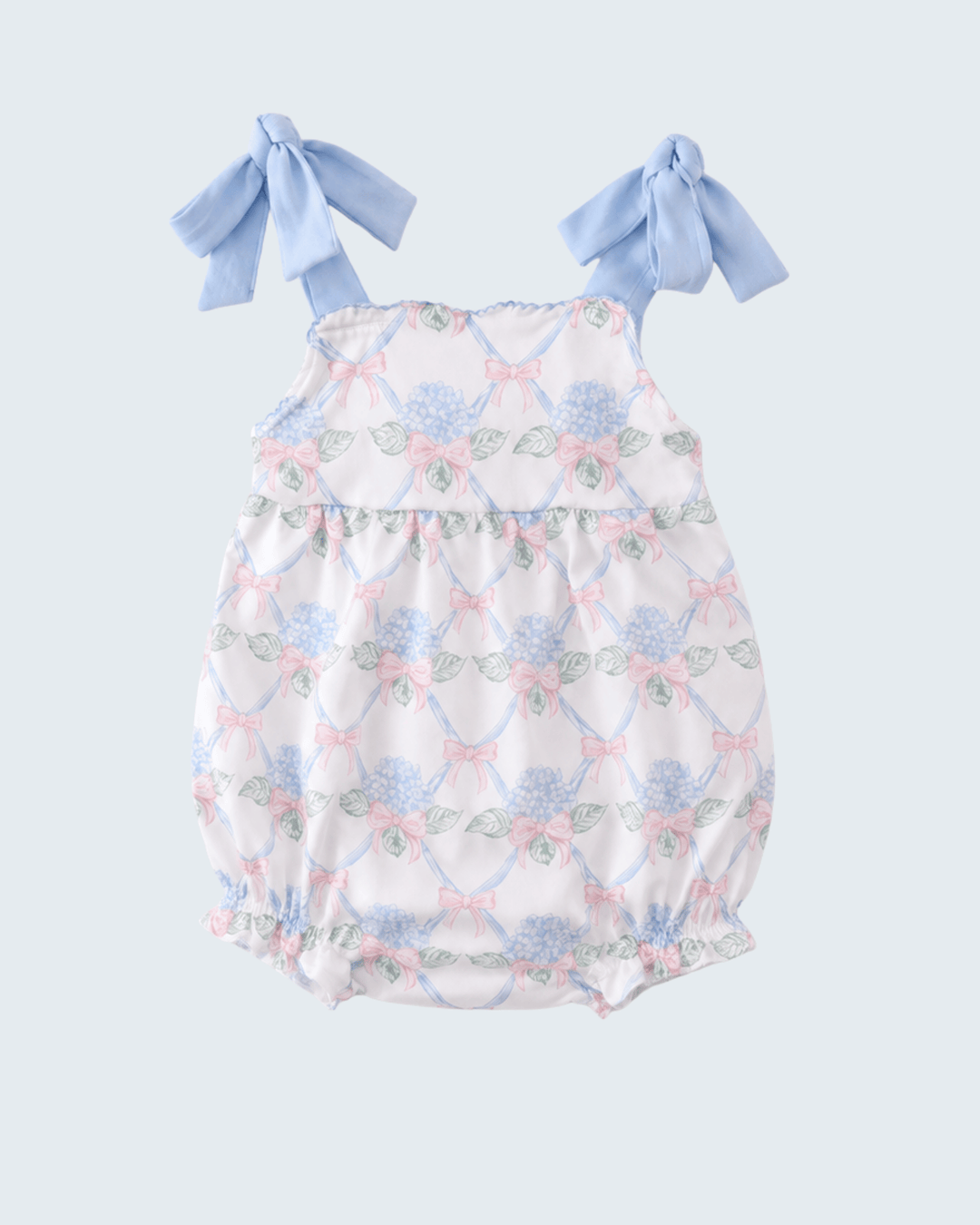 Floral baby romper with blue bows on a light gray background