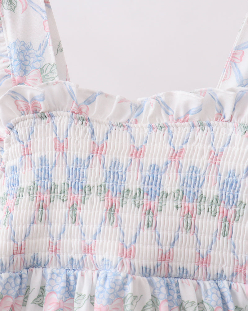 Close-up of a floral dress with ruffled details on a white background