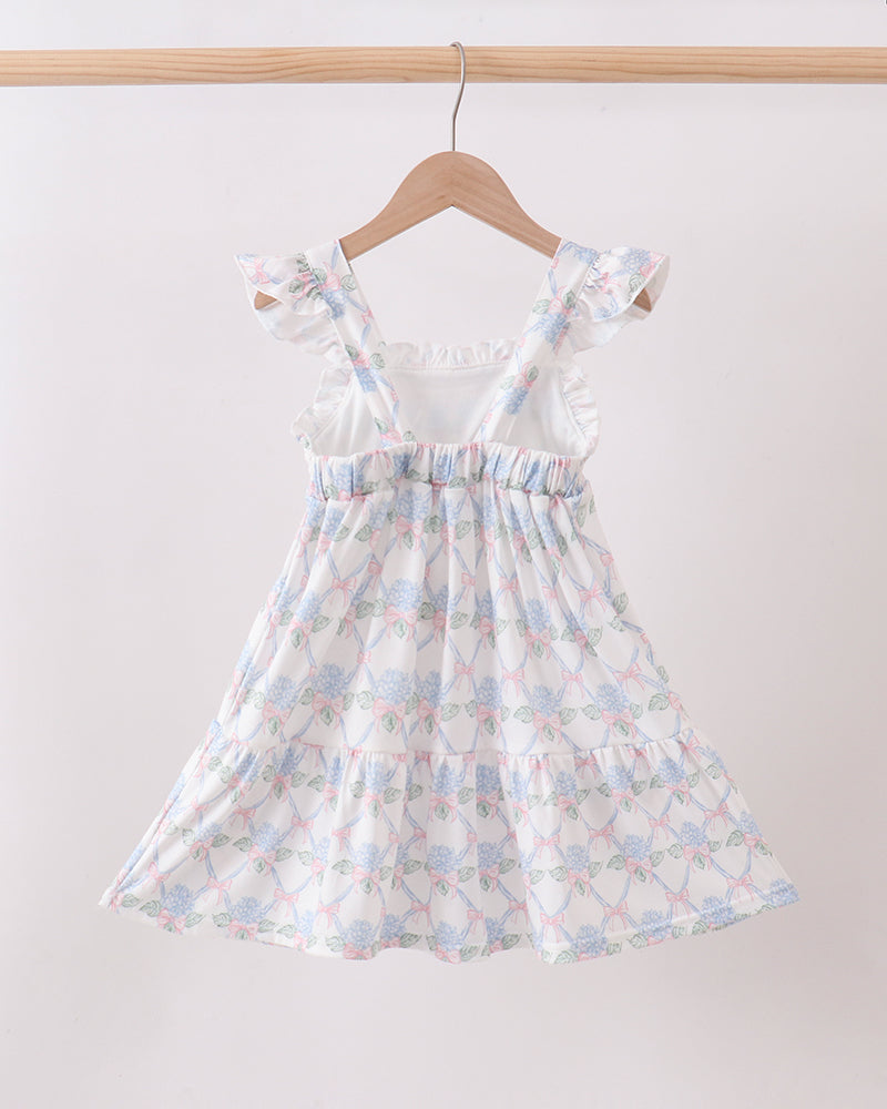 Floral dress on a hanger against a white background