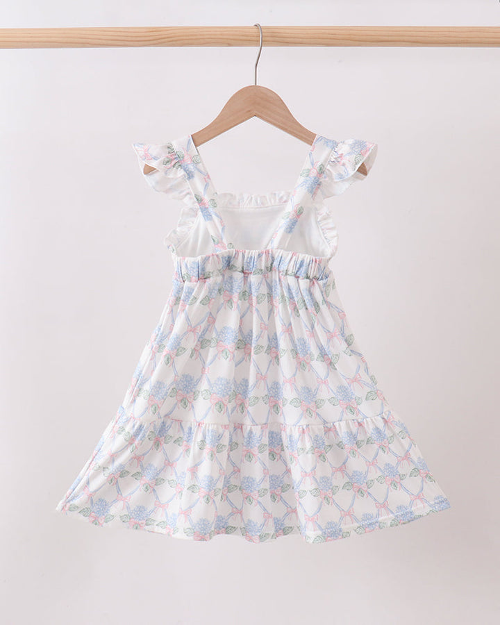 Floral dress on a hanger against a white background