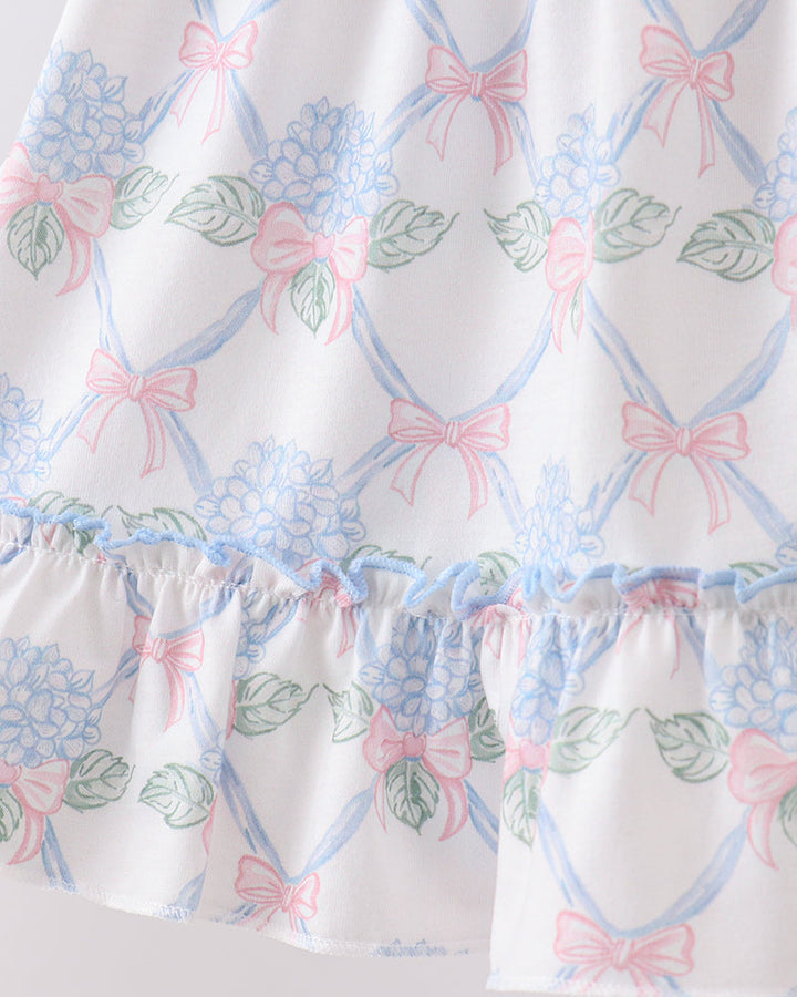 Dress with floral and bow pattern on a white background