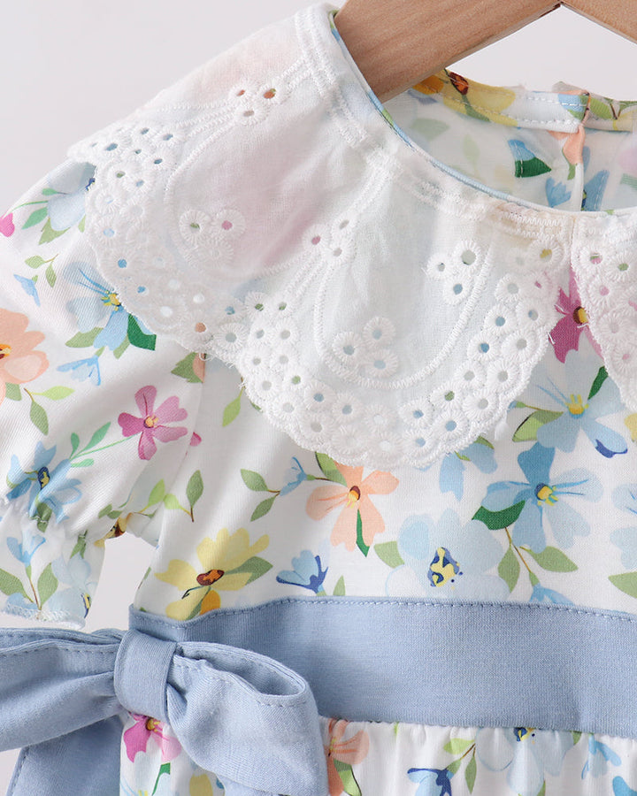 Floral dress with a white lace collar and blue trim on a light background