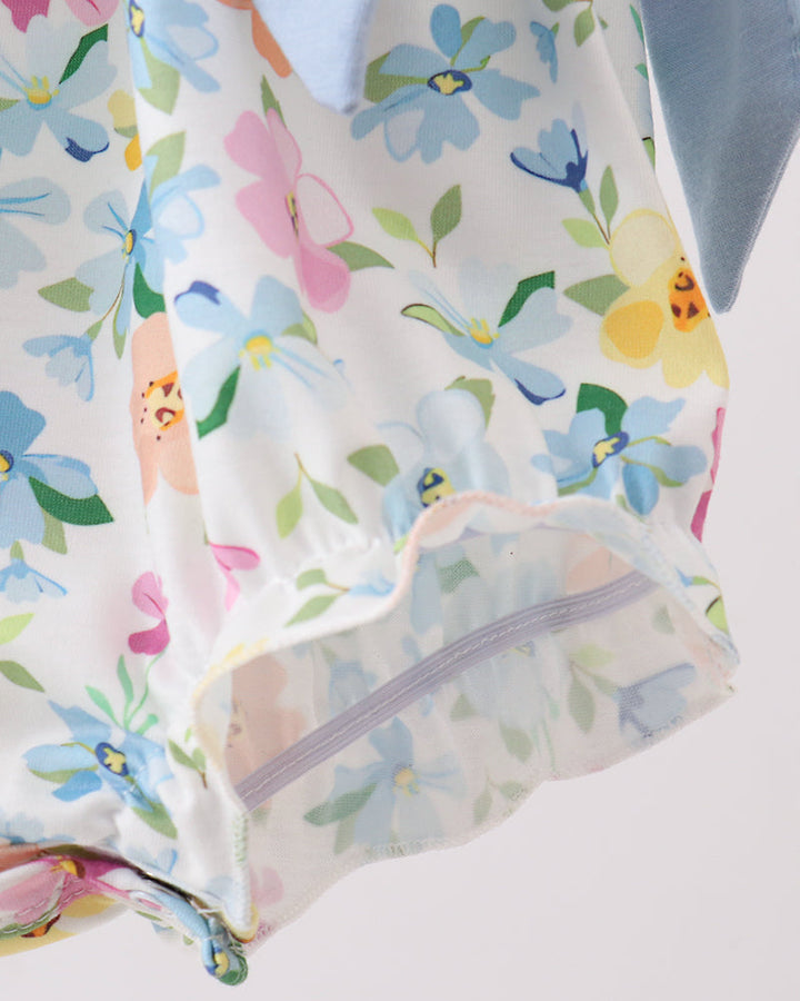 Floral-patterned fabric with colorful flowers and leaves on a white background