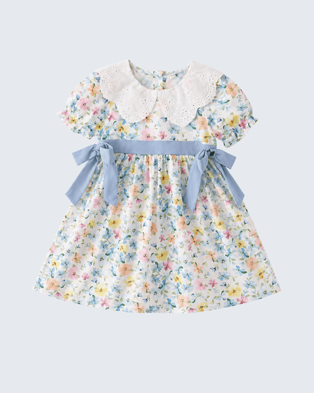 Floral dress with a blue ribbon on a light gray background