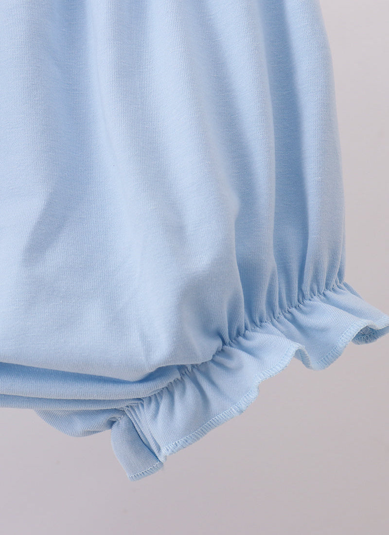 Light blue fabric with ruffled edges on a beige background