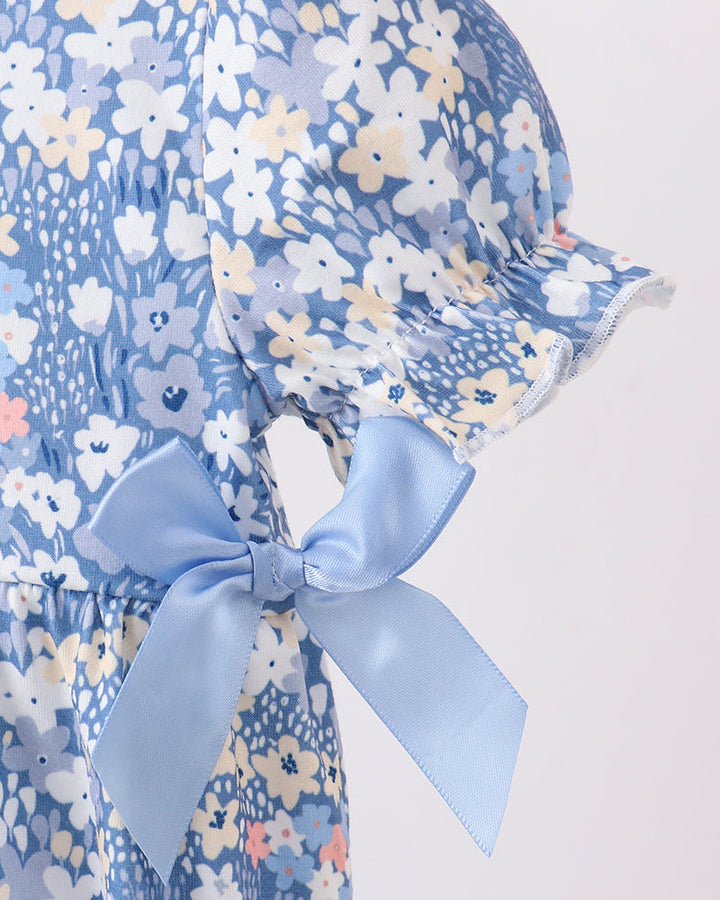 Blue floral baby bubble romper close-up with tied back waist bow and flutter sleeve