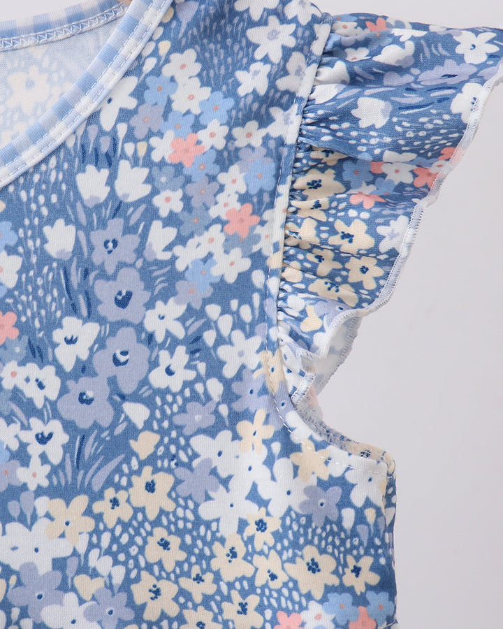Blue floral dress close-up showing flutter sleeve ruffle and round neckline