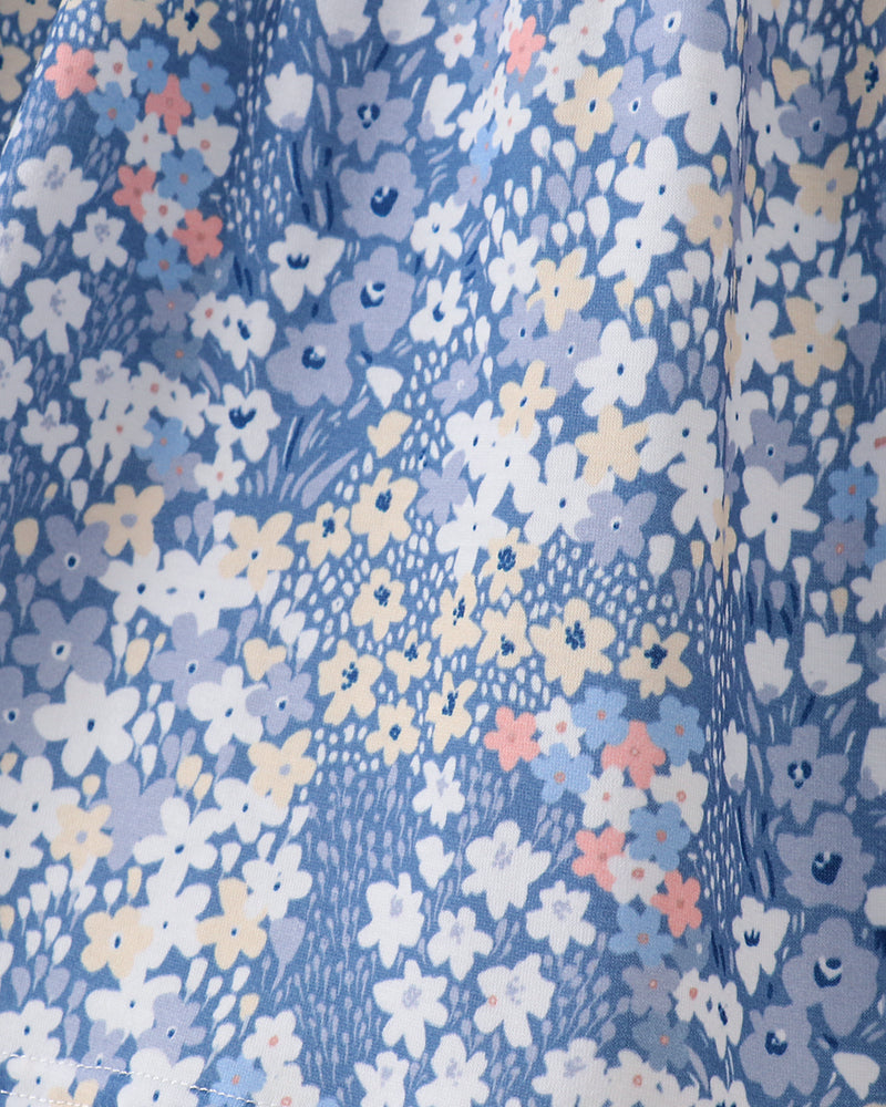Blue floral print fabric with small white and peach flowers