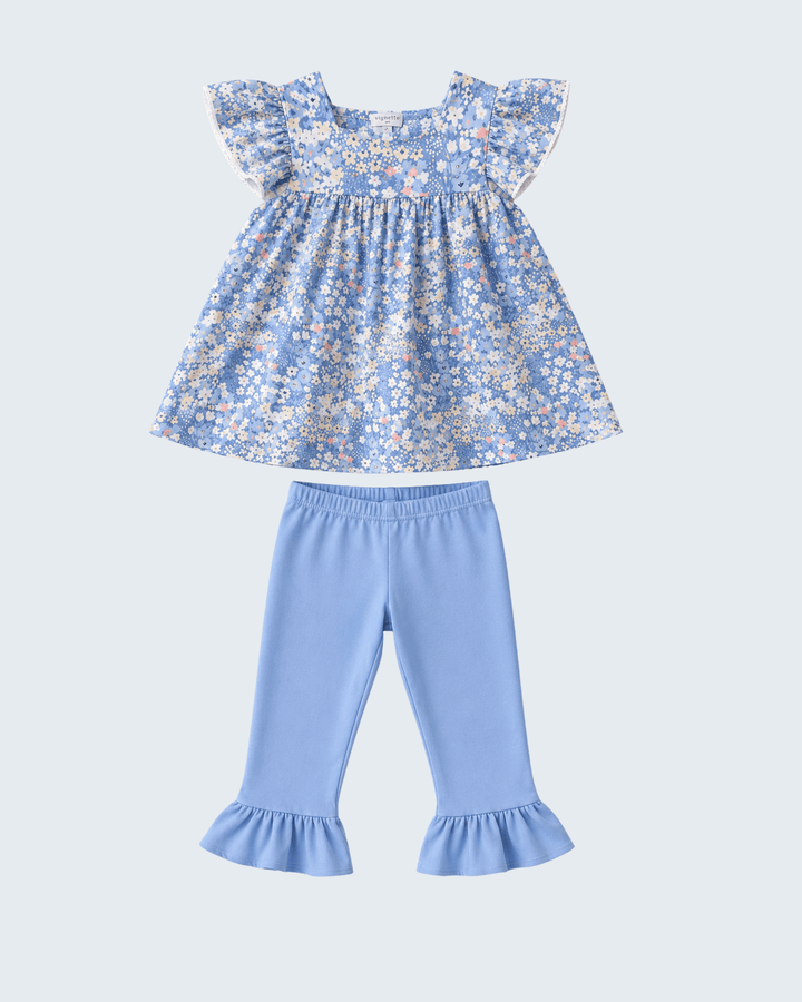 Floral ruffle top with light blue pants featuring ruffled cuffs, laid flat