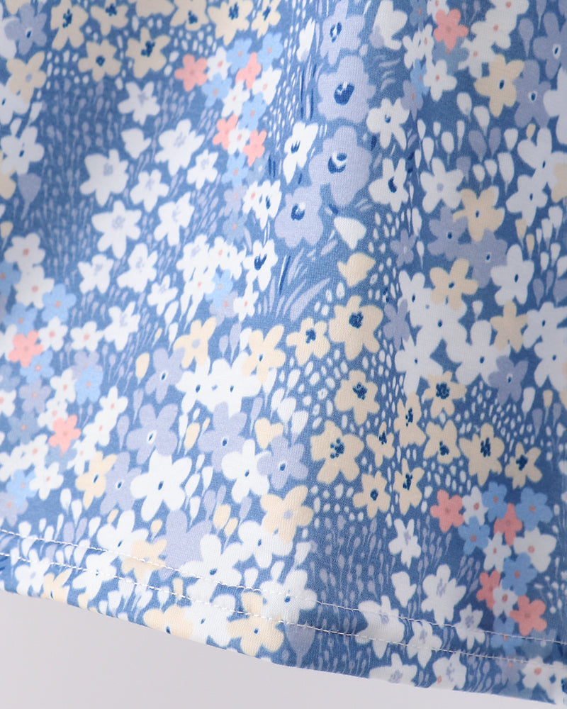 Blue floral top with puff sleeves and gathered waist seam detail
