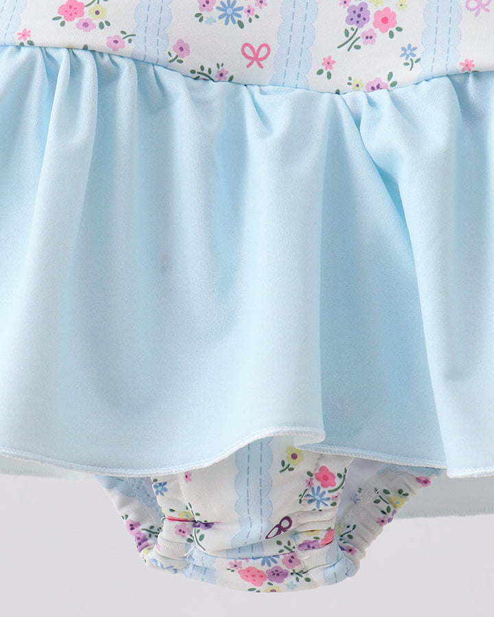 Floral-patterned swimsuit with a light blue waistband on a white background