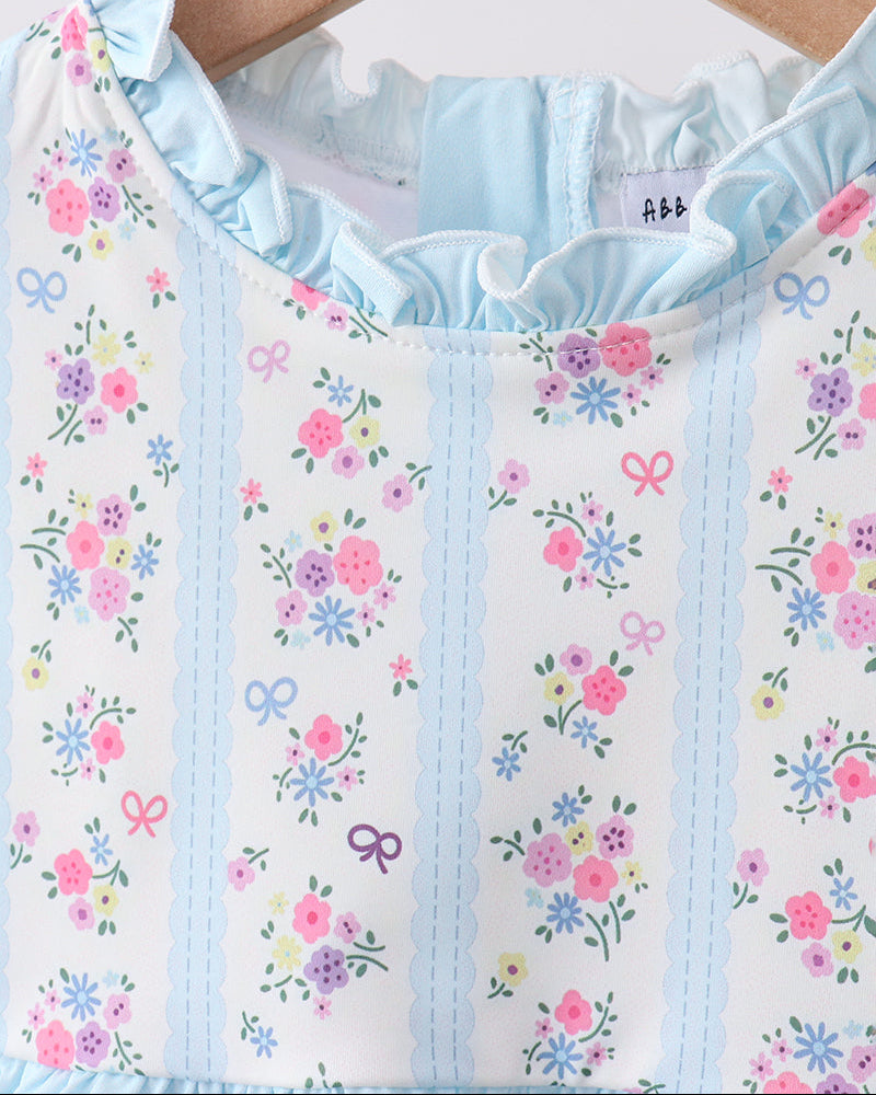 Swimsuit with floral pattern and ruffled collar on a hanger